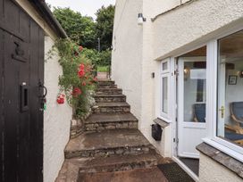 An outdoor area with stone steps and a door at Squirrel Cottage in Bassenthwaite