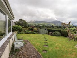 A garden with chairs and a shed at Squirrel Cottage in Bassenthwaite