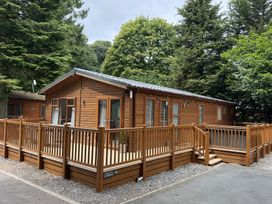 A wooden lodge with decking at Cherry Tree Lodge, Calgarth 37, White Cross Bay near Windermere