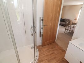 A bathroom with a shower and sink at Ilgram St Newlyn East