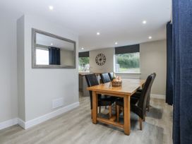 A dining room with a table and chairs at Caledfryn Tyn-y-Gongl