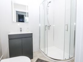 A bathroom with a shower and sink at Caledfryn in Benllech