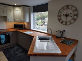 A kitchen with a sink and microwave at Caledfryn in Benllech