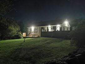 House exterior with garden lighting at Caledfryn in Benllech