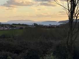An outdoor view of islands and houses with trees at Caledfryn Benllech