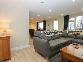 A living room with a sofa and coffee table at Caledfryn in Benllech