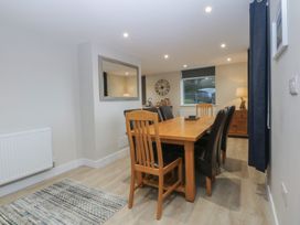 A dining room with a table and chairs at Caledfryn in Benllech