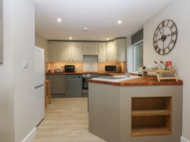 A kitchen with a sink and appliances at Caledfryn in Benllech