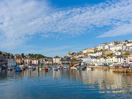 A harbor with boats and buildings along the waterfront in Egret Brixham
