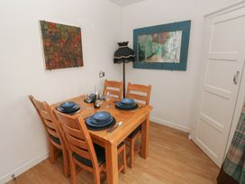 A dining room with a table set for dinner at Llys-Yr-Onnen in Carmarthen