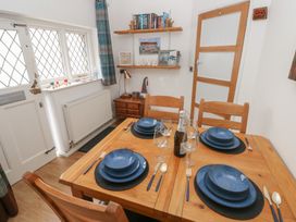 A dining room with a table set for meals at Llys-Yr-Onnen in Carmarthen