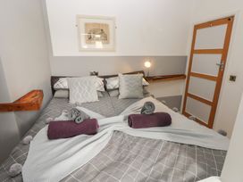 A bedroom with a bed and towels at Llys-Yr-Onnen in Carmarthen