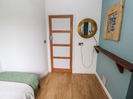 A bedroom with a bed and wall decor at Llys-Yr-Onnen in Carmarthen