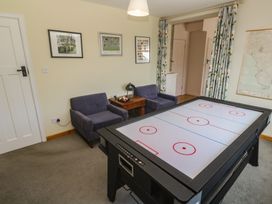 A game room with an air hockey table and seating at Penmarth House in Coverack