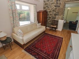 A living room with a sofa and rug at Penmarth House Coverack