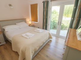 A bedroom with a bed and dresser at Penmarth House in Coverack
