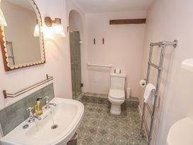 A bathroom with sink, toilet, and shower at Penmarth House Coverack