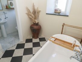 A bathroom with a bathtub and sink at Penmarth House Coverack