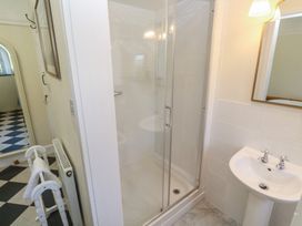 A bathroom with a shower and sink at Penmarth House Coverack
