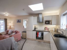 A kitchen with cabinets and a sofa at Weydale Avenue in Scarborough
