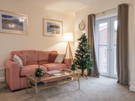 A living room with a sofa and Christmas tree at Weydale Avenue in Scarborough