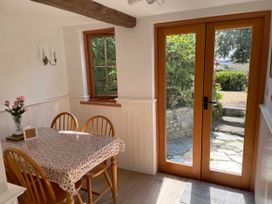 A dining room with a table and chairs at Bell Buoy Cottage in Morwenstow