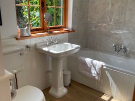 A bathroom featuring a bathtub, sink, and toilet at Bell Buoy Cottage Morwenstow