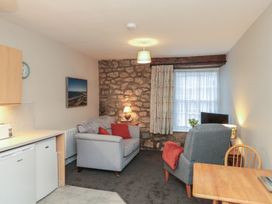 A living room with a sofa and armchair at Beck View