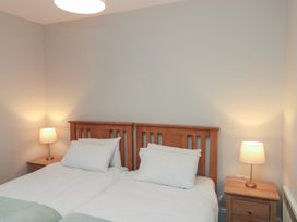 A bedroom with two beds and bedside lamps at Beck View