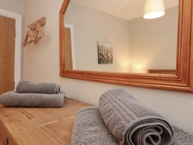 A bathroom with towels on a table and a mirror at Beck View