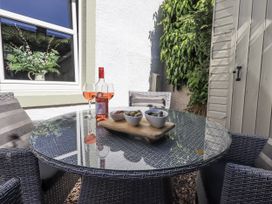 A table with wine and snacks at Hideaway Cottage in Penrith