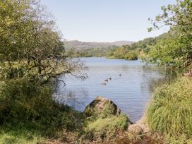 A lake with ducks and trees at Hideaway Cottage Penrith