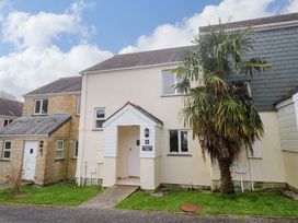 A building with palm tree and pathway at Pheasants Walk in Falmouth