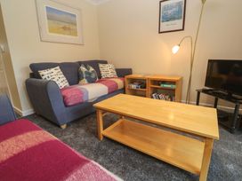 A living room with a sofa and coffee table at Pheasants Walk in Falmouth