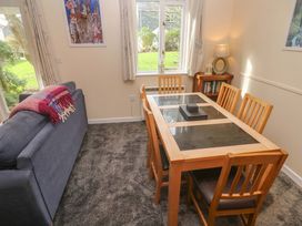 A dining room with a table and chairs at Pheasants Walk in Falmouth