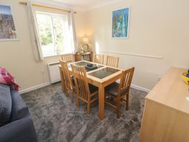 A dining room with a table and chairs at Pheasants Walk in Falmouth