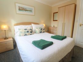 A bedroom with a bed and towels at Pheasants Walk in Falmouth