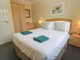 A bedroom with a double bed and wardrobe at Pheasants Walk in Falmouth