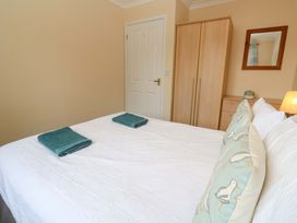 A bedroom with a bed and towels on it at Pheasants Walk in Falmouth