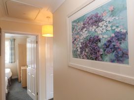 A hallway with a painting on the wall at Pheasants Walk in Falmouth