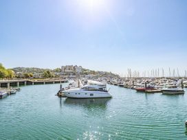 A marina with boats docked on water and buildings in the background at Flat 3 Channel View in Torquay