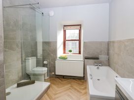 A bathroom with a shower and bathtub at Beckside Farm Bootle near Millom, Cumbria