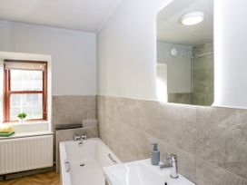A bathroom with a bathtub and sink at Beckside Farm Bootle near Millom, Cumbria