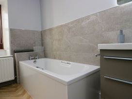 A bathroom with a bathtub and sink at Beckside Farm Bootle near Millom Cumbria