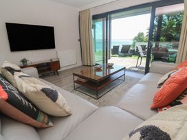A living room with a sofa, coffee table and television at Peninsula Apartment 2 St Ives