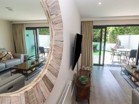 A living room with a sofa and television at Peninsula Apartment 2 in St Ives