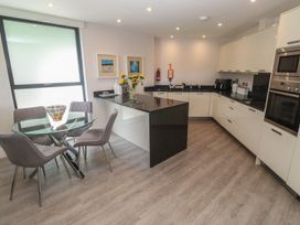 A kitchen with a dining table and chairs at Peninsula Apartment 2 St Ives
