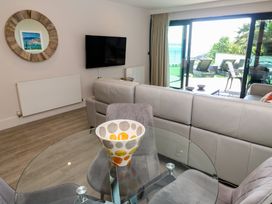 A living room with a dining table and sofa at Peninsula Apartment 2 in St Ives