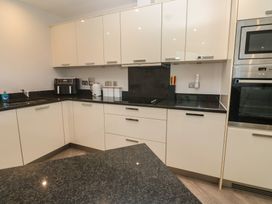 A kitchen with cabinets and appliances at Peninsula Apartment 2 in St Ives