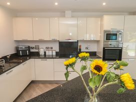 A kitchen with cabinets and appliances at Peninsula Apartment 2 in St Ives
